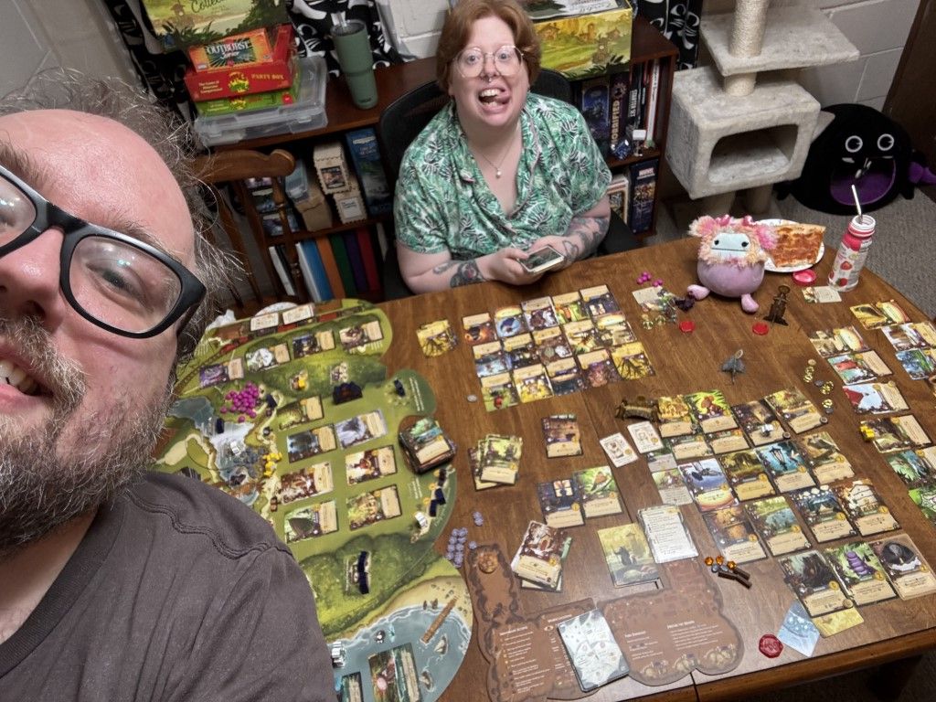 Me and my wife at table with board game.